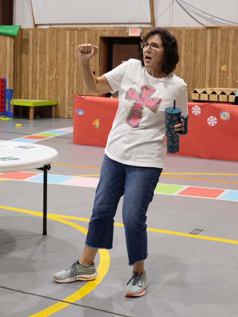 A leader directing game time in the gym at VBS 2026